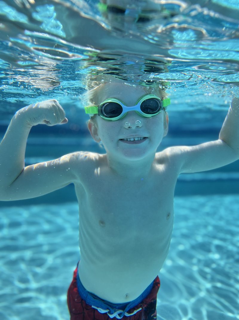 Child swimming underwater towards the camera
