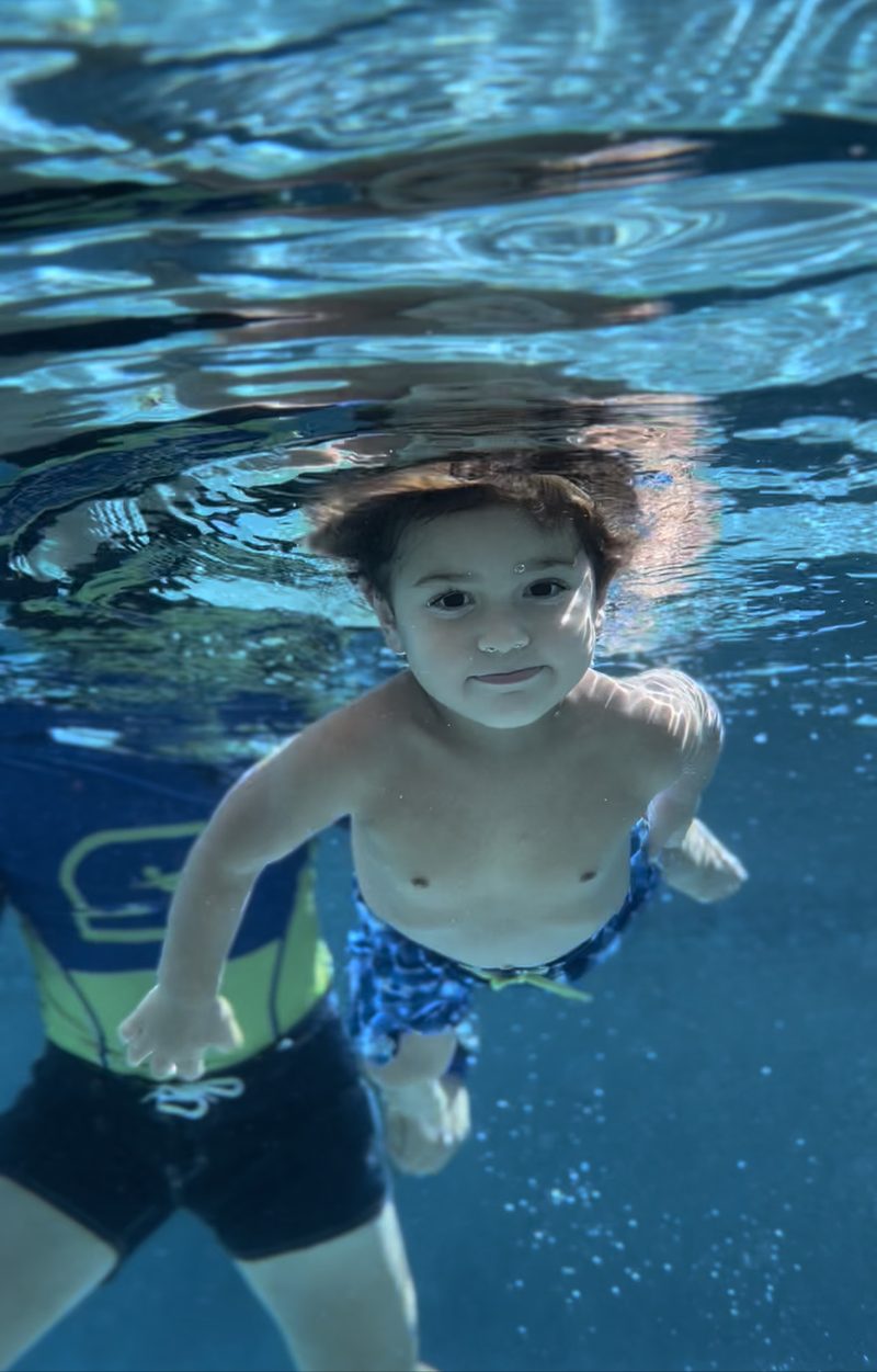Child gliding underwater during a lesson