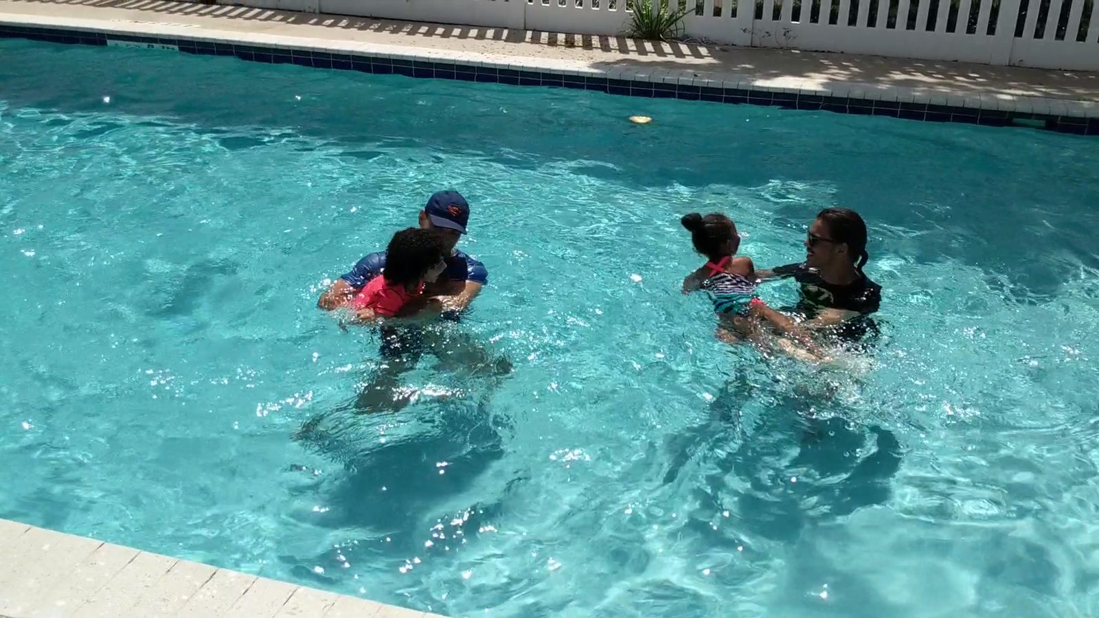 Children in the pool during a small group lesson