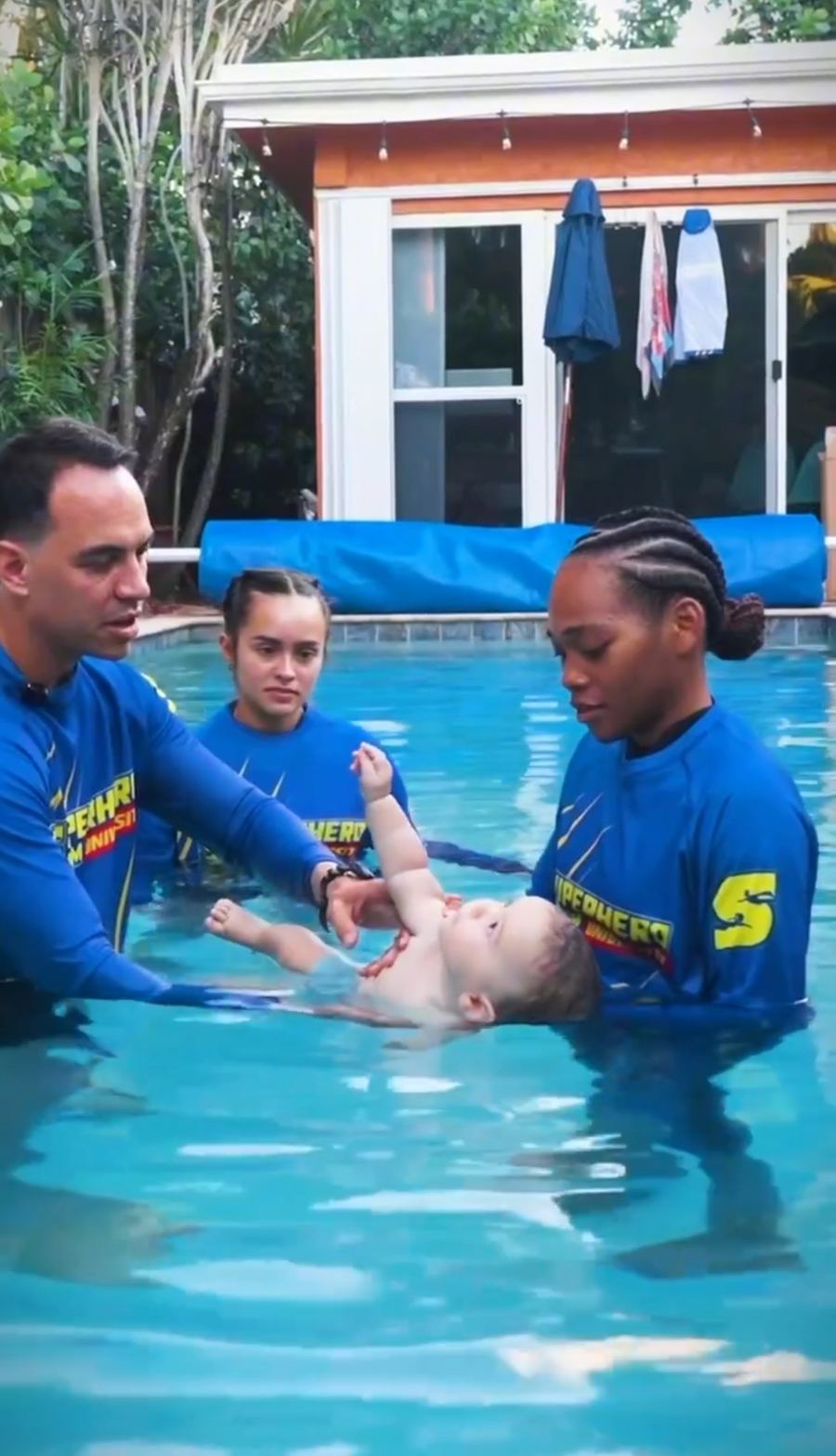 Superhero Swim coaches teaching an infant in the pool