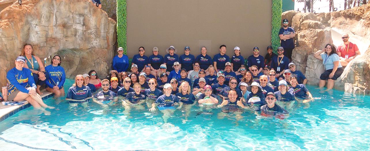Superhero Swim instructors together in the pool at the 2026 retreat