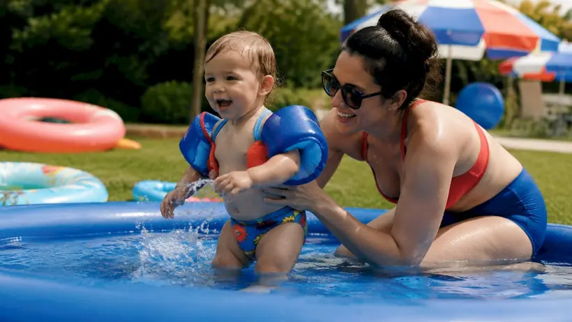 Parent holding toddler during swim lesson