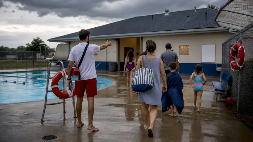 Lifeguard leading pool evacuation during storm