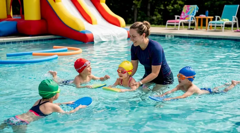 Swim instructor teaching children in pool