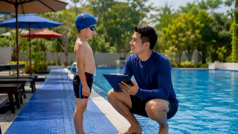 Child undergoing swim skill assessment with instructor