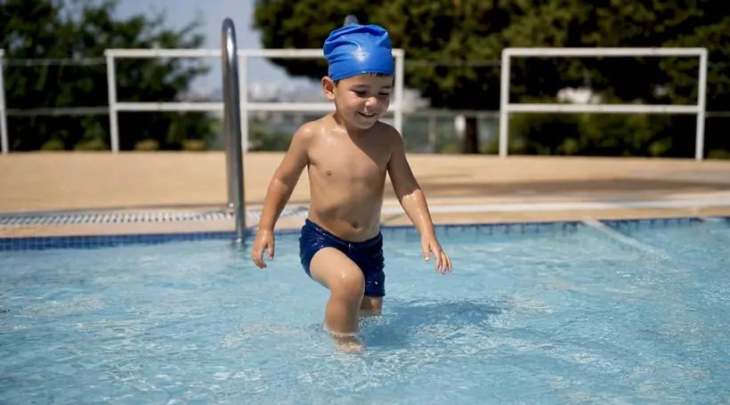 Child taking incremental swimming challenge step