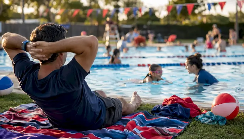 Father attentively watching child's swim practice