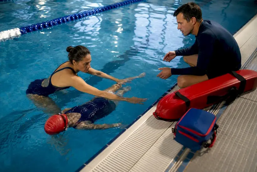 Instructors practicing survival swim techniques