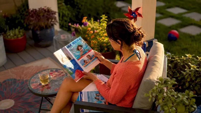 Mother reviewing swim lesson brochures at home