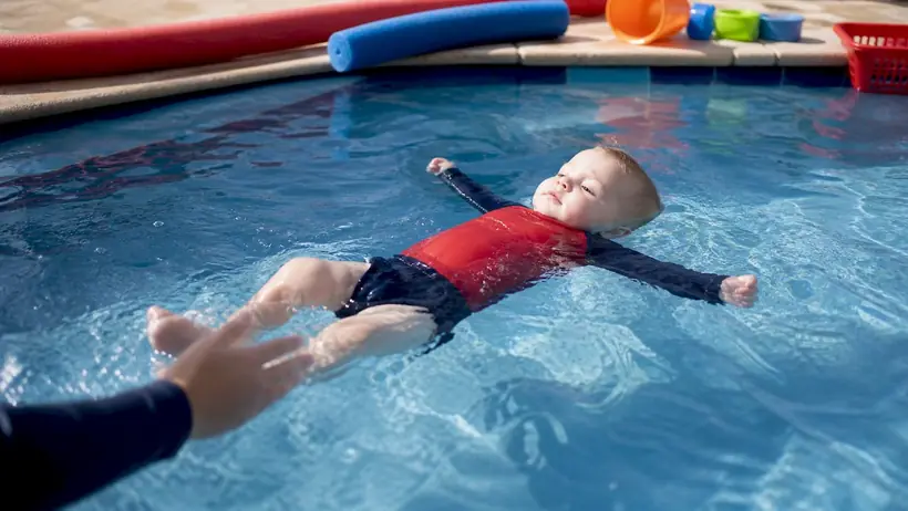 Toddler floating independently in teaching pool
