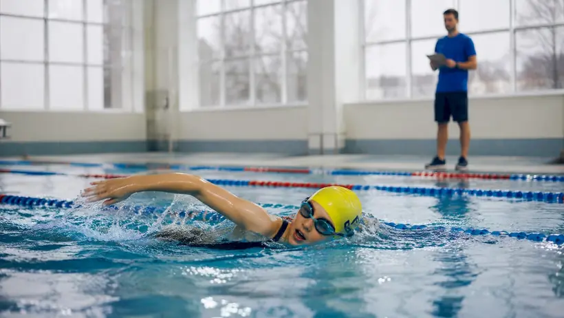 Girl swimming during skill-building lesson